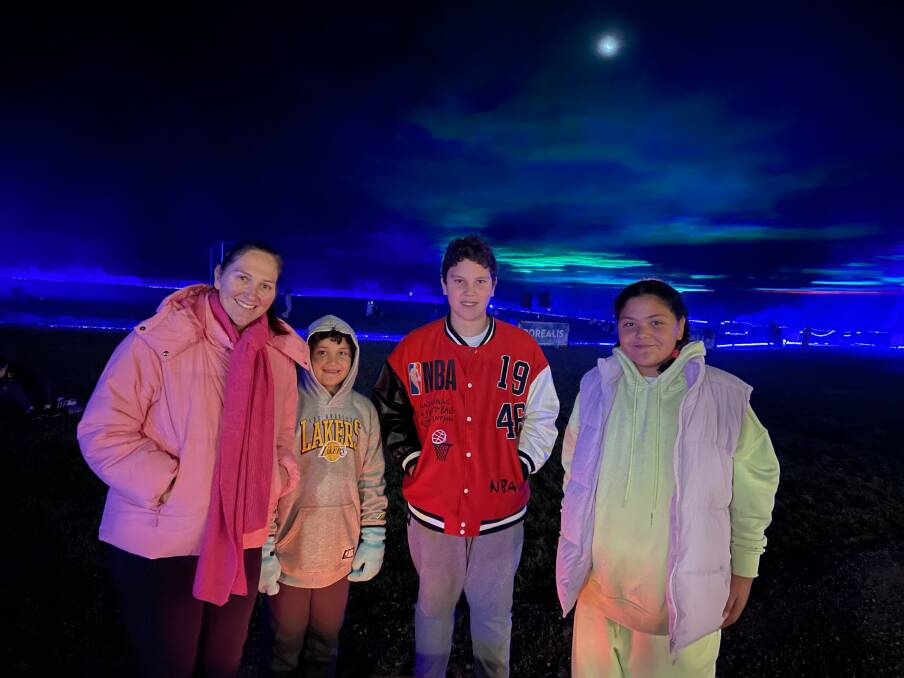 Karen Cooper, Osten, Odin and Clara Fa'asolo admired Borealis in the Vines - projections that mirror the Northern Lights, on May 25 at Centennial Vineyards. Picture by Briannah Devlin