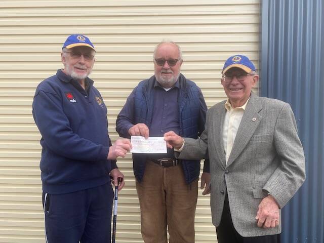 Bowral Lions Club President Brian Morand (left) and secretary Bill Bransom (right) present Challenge Southern Highlands general manager Tony McElhinney with $2000 to go towards the organisation's second house for disabled people to live in. Picture supplied 
