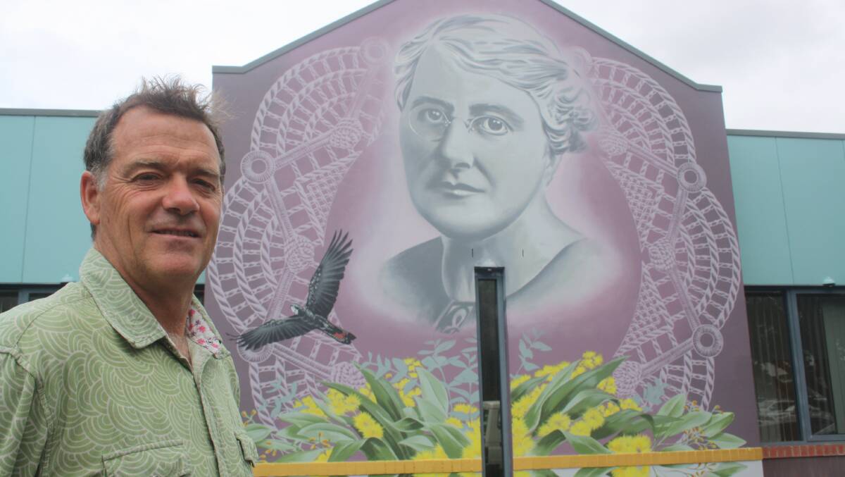 Woollamia artist Clayton Campion with the mural he painted outside the Nowra CWA rooms in Berry Street. Picture by Glenn Ellard.