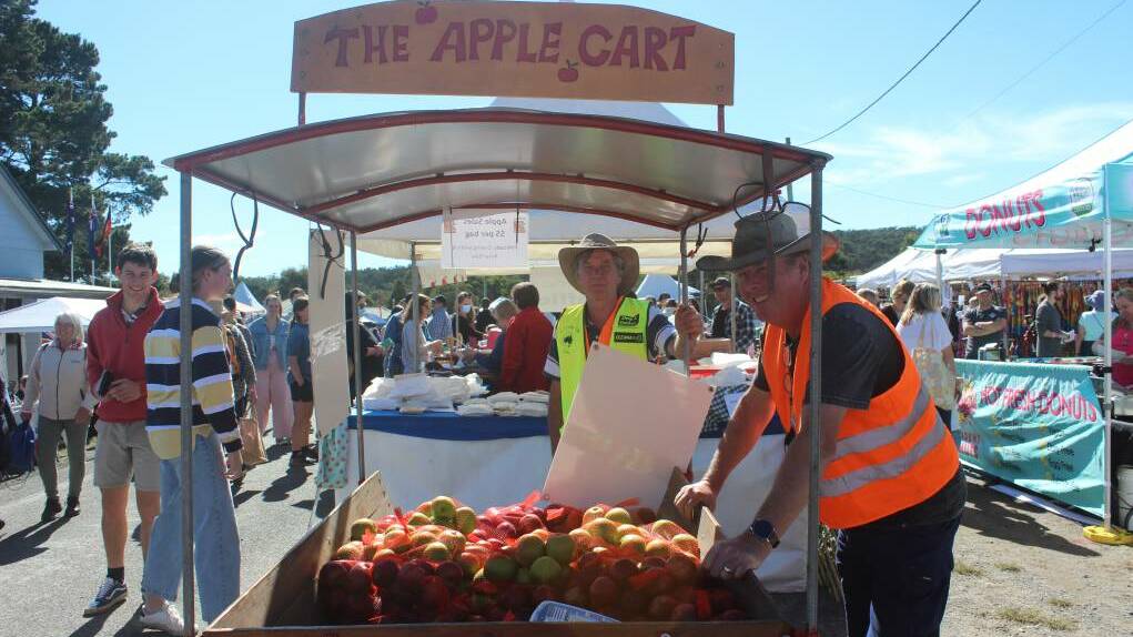 Volunteers Andrew Beeston and Geoff Schneider manning The Apple Cart at last years festival. Photo: Sophie Bennett