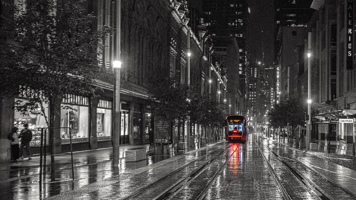 Sydney's George Street, Lonely tram and sheltering Couple, April 2020. Picture: John Swainston
