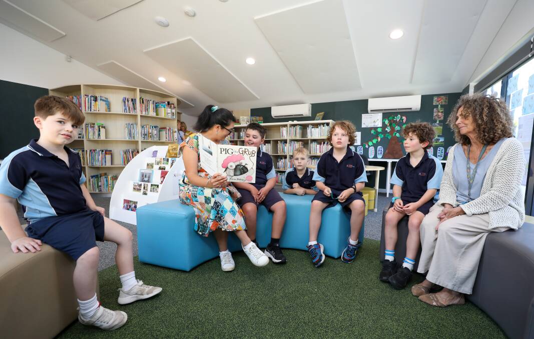 Teacher Georgia Brungs and teacher's aid Gail Wistow with students L-R Archer Hottes, Cruz Agoris, Banjo Horvat, Archie Meyn, and Charlie Casey in the newly built library at the Aspect South Coast School in Corrimal on October 24. Picture: Adam McLean 