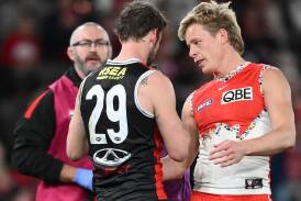 Sydney star Isaac Heeney checks on St Kilda opponent Jimmy Webster after their incident on Sunday. (Joel Carrett/AAP PHOTOS)